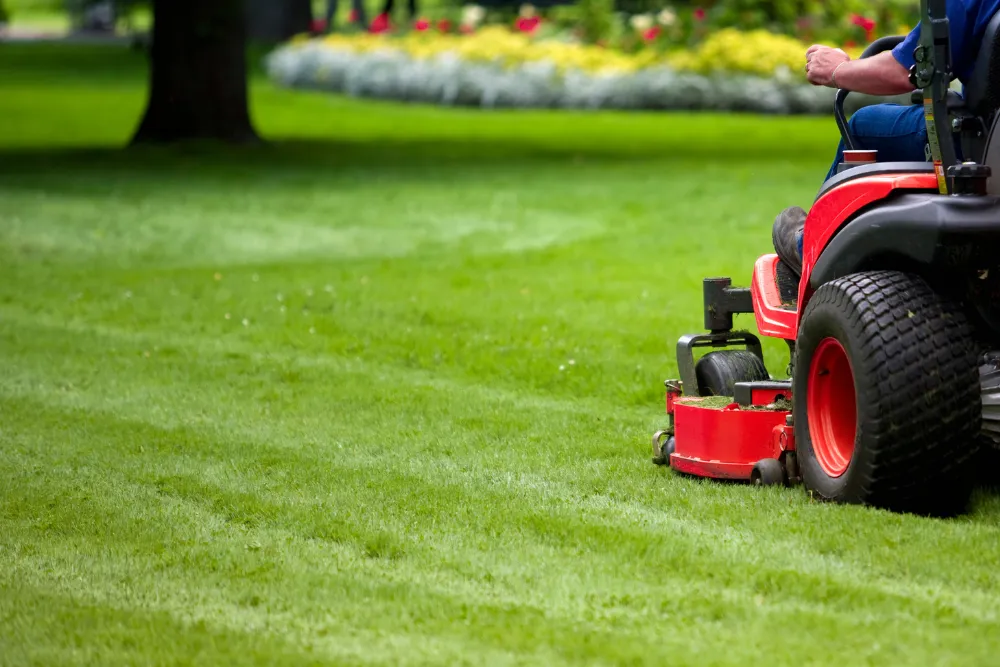 Riding lawn mower cutting grass in Dover-Foxcroft ME